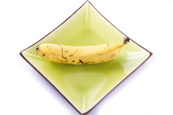 Plátano en plato colorido —  Fotos de Stock