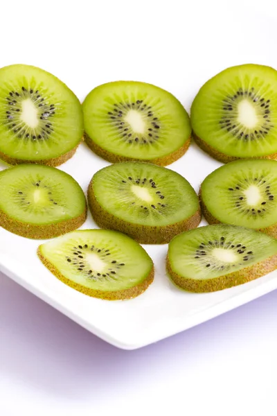 Kiwi slices on white plate — Stock Photo, Image
