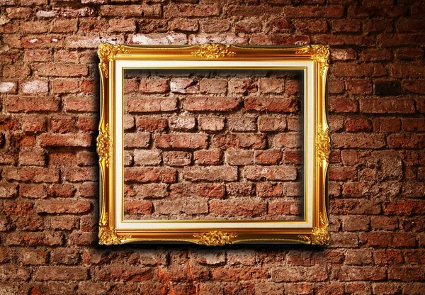 stock image Golden frame against grunge brick wall