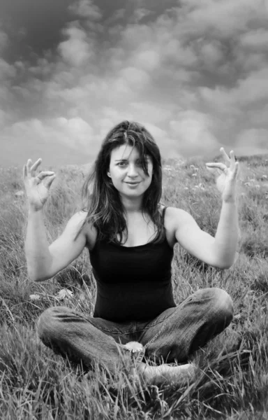 Frau meditiert auf einem Feld — Stockfoto