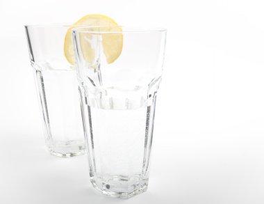 A glass of mineral water with a lemon clipart