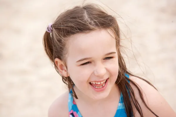 stock image A beautiful young girl on the beach