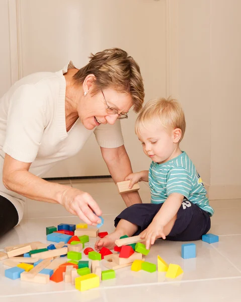 stock image A little boy plays with his grandmother