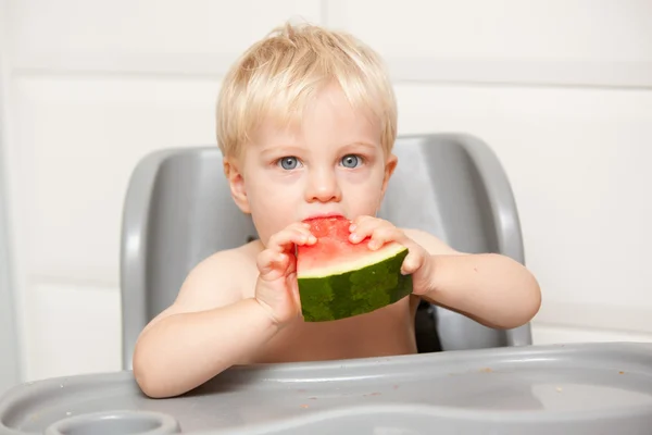 A adorable toddler eats watermelon Obraz Stockowy