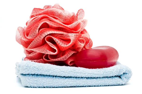 Bath rose and soap bar on top of blue towel — Stock Photo, Image