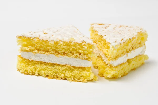 Side view of two triangles of sponge cookies with skimming filli — Stock Photo, Image