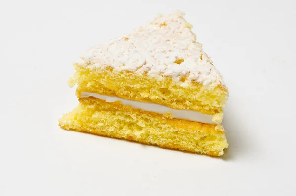 Side of the Triangle of sponge cookie with skimming filling — Stock Photo, Image