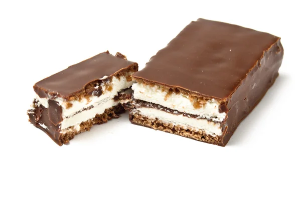 Chocolate bar with skimmings filling cut with second half — Stock Photo, Image