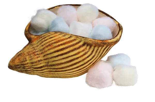 Periwinkle filled with colored cotton balls spilled — Stock Photo, Image