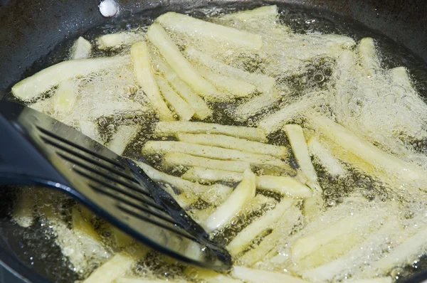 stock image Arranging potatoes in a pan during frying