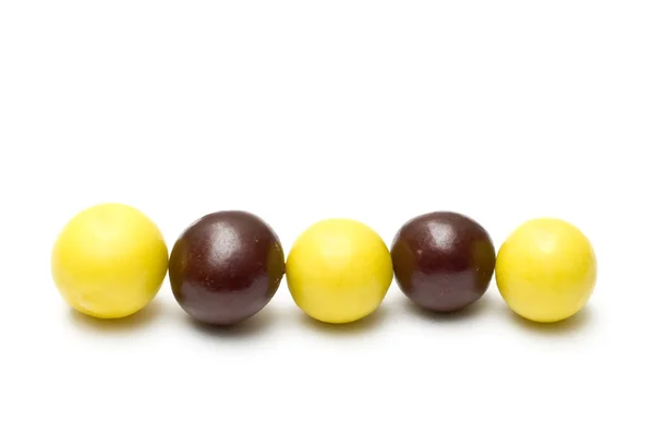 stock image Line of chocolate balls and chewing gums