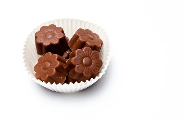 Daisy shaped chocolate assortments in a paper basket — Stock Photo, Image