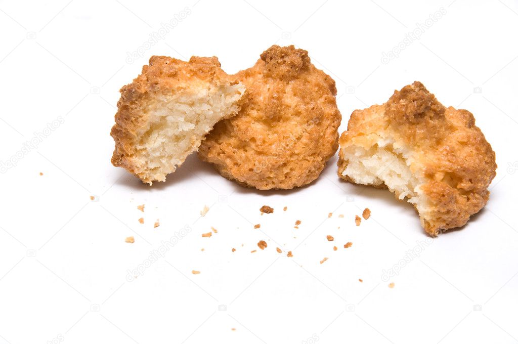 Three coco biscuits with bites and crumbs