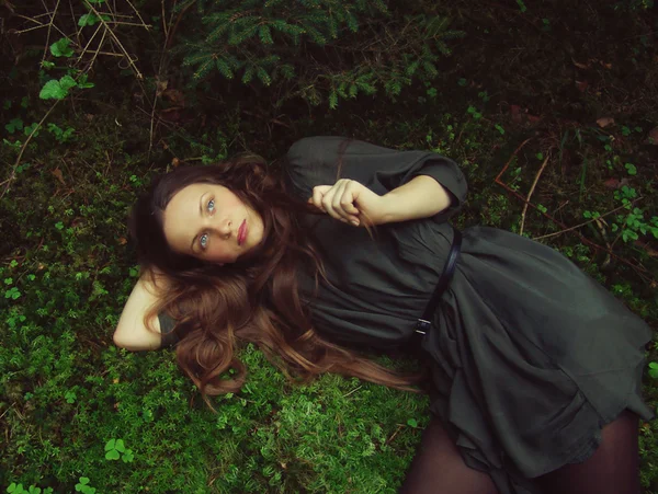 Flickan liggande i skogen — Stockfoto