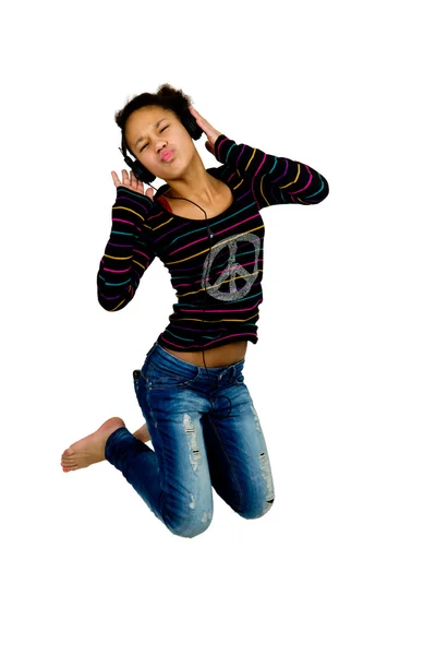 Afro american jumping while listening to music with headphones — Stock Photo, Image