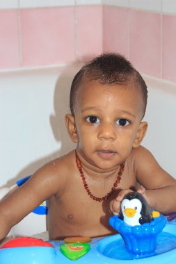 African American baby in the bath with black toy clipart