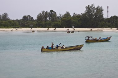 Boatmen in traditional boats clipart