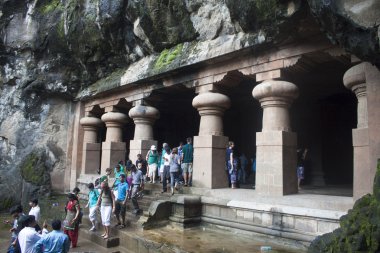 Tourists visit caves on Elephanta island clipart