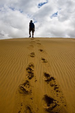 Kumul üzerinde yürüyen adam