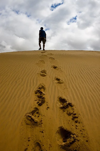 stock image Man walking on a sand dune