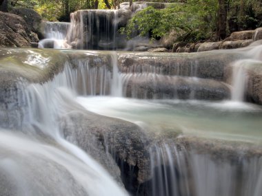 Waterfall with water flowing around clipart