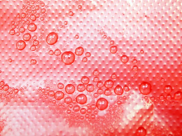 Water drops on a red background — Stock Photo, Image