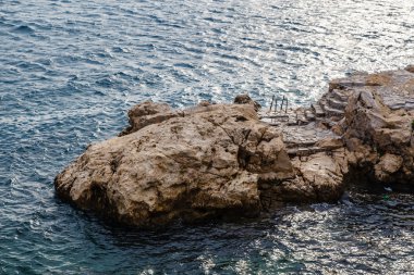 Rock and the Stairs Leading to the Sea in Rovinj, Croatia clipart