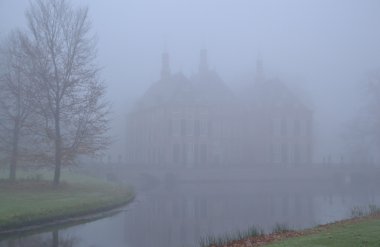 Castle Duivenvoorde in the fog. clipart