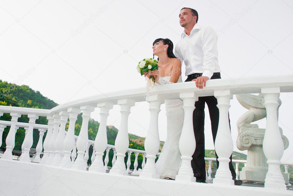 Happyness couple standing on the balcony isolated