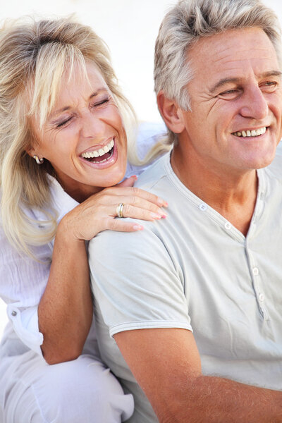 Happy mature couple laughing.