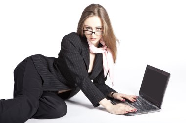 A girl in glasses with a computer on a white background