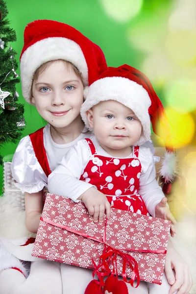 stock image Beautiful girls sister in Santa hats