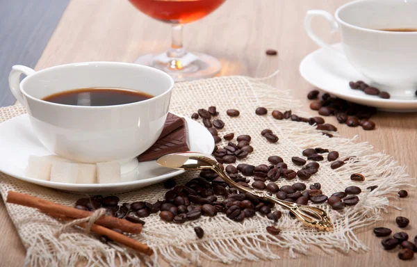 Black coffee with sugar chocolate and cinnamon — Stock Photo, Image