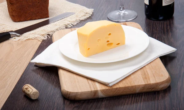 Cheese with wine, knifes and glass — Stock Photo, Image