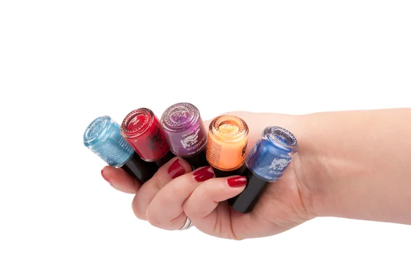 A hand holding colorful nail-polish — Stock Photo, Image