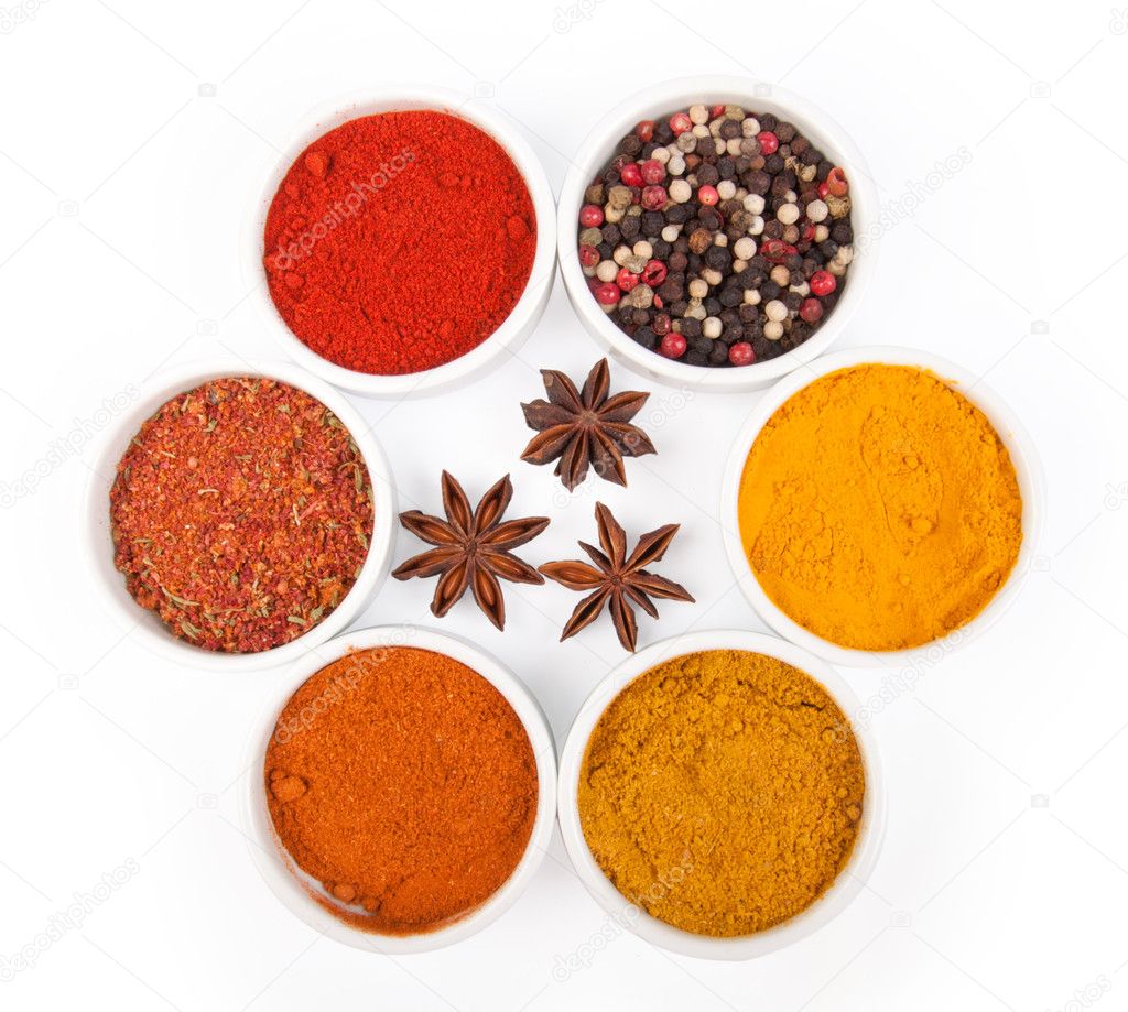 Spices in porcelain plates iaolated on white