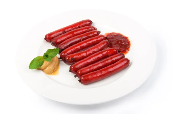 Roasted sausages on a porcelain plate — Stock Photo, Image