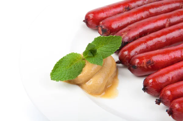 Roasted sausages on porcelain plate — Stock Photo, Image