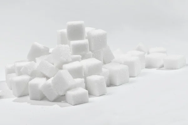 Stack of white sugar cubes. Chaotic version — Stock Photo, Image