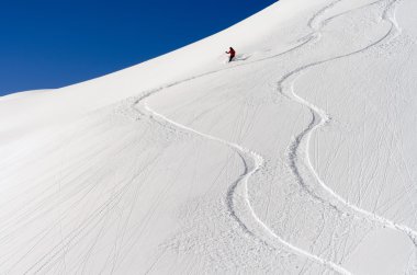 Skier in the deep powder snow clipart