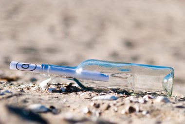 Message in a bottle in the sand clipart