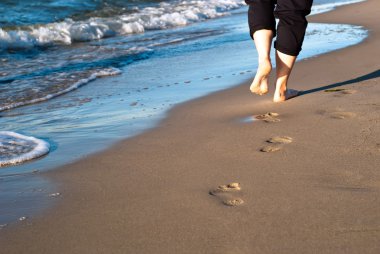 Footprints on the beach clipart