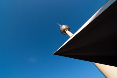 Television tower against a blue sky V1 clipart