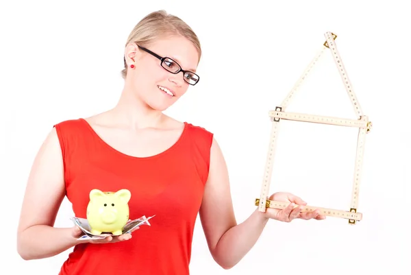 Young woman with house symbol and piggy bank — Stock Photo, Image