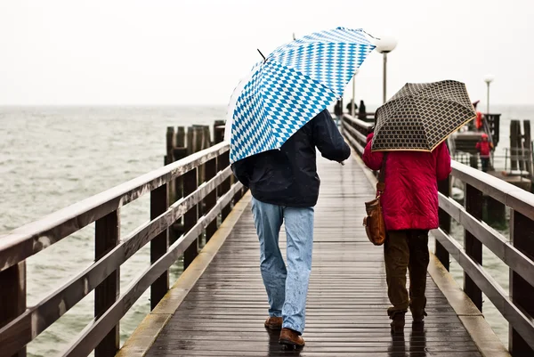 stock image With umbrella on the pier