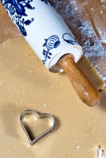 Dough and rolling pin with heart ramekins — Stock Photo, Image