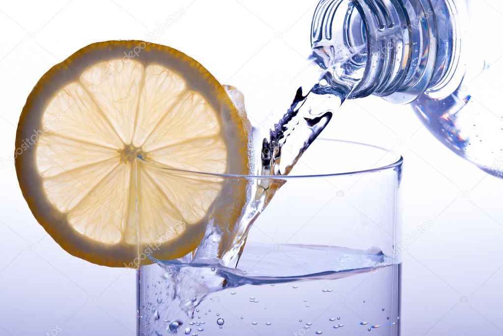 Pour glass of water with lemon