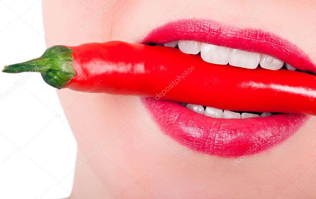A red pepper between the teeth