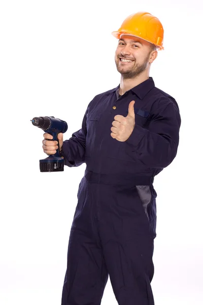 Retrato de un constructor con un taladro en las manos sobre un fondo blanco —  Fotos de Stock