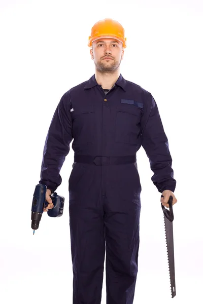 Retrato de um construtor com uma broca e serra em suas mãos sobre um fundo branco — Fotografia de Stock